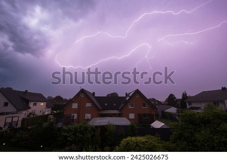 Lightning strike from a thunderstorm at night Royalty-Free Stock Photo #2425026675