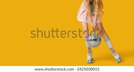 Beautiful young woman with vintage roller skates and disco ball on yellow background with space for text