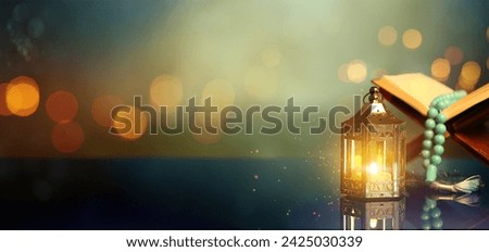 Arabic lantern, Koran and prayer beads on color background with space for text
