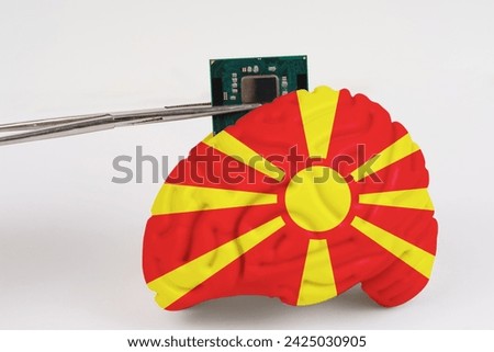 On a white background, a model of the brain with a picture of a flag - Macedonia, a microcircuit, a processor, is implanted into it. Close-up