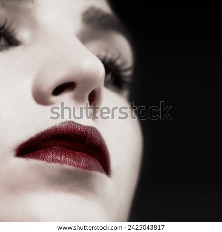 Woman, lips and gothic makeup in studio for beauty, cosmetics and vampire, witch or dark aesthetic. Face of model with lipstick closeup for Halloween, art and color at night or on a black background