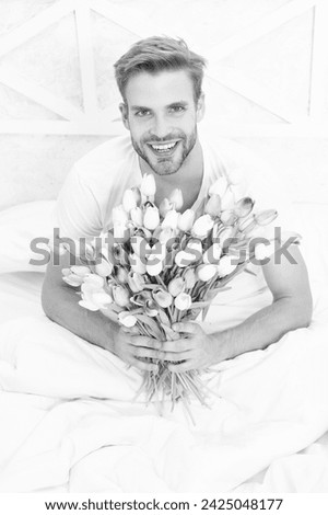 image of romantic man with march tulips bouquet. romantic man with march tulips. romantic man