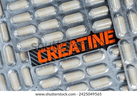 Creatine capsules or pills food supplement . Overhead close up detail. Royalty-Free Stock Photo #2425049565