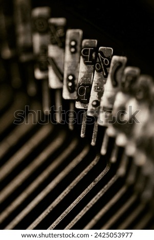 Closeup of old typewriter plates strikers strykers with letters and symbols for typing. Shallow depth of field