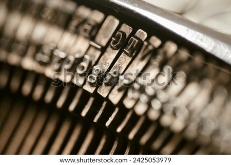 Closeup of old typewriter plates strikers strykers with letters and symbols for typing. Shallow depth of field