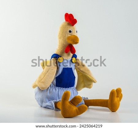 Soft children's toy. Multi-colored rooster on a white background.