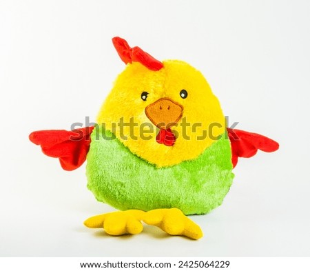 Soft children's toy. Multi-colored rooster on a white background.