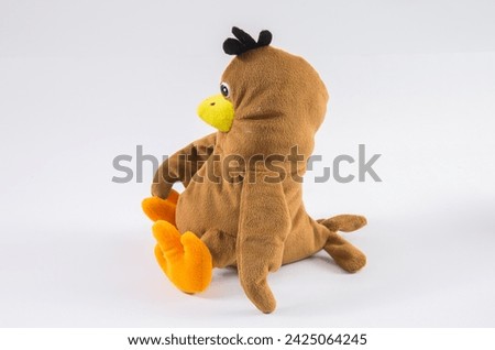 Cute plush brown parrot on a white background.