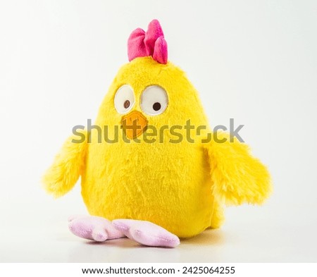 Soft children's toy. Yellow chicken on a white background.