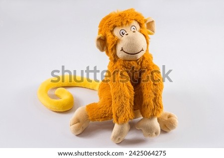 Plush children's toy monkey on a white background.