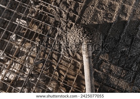 Iron frame for foundation floor, building site, top view. Closeup reinforced concrete structures, knitting of metal reinforcing cage. Royalty-Free Stock Photo #2425077055