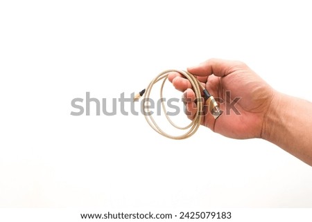 Hand holding USB cable isolated on white background.