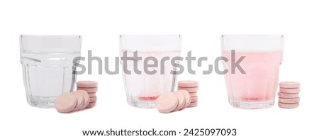Vitamin C effervescent tablets with orange flavor drops and dissolves in a glass of water isolated on a white background. The concept of health. Medicine concept.