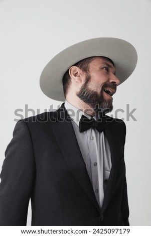 Portrait of optimistic mature man wearing fedora hat looking away. Vertical.