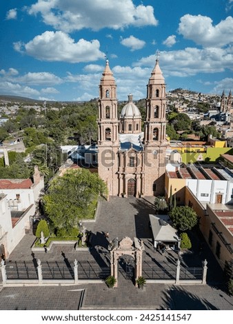The grand facade of San Luis de La Paz Cathedral in Guanajuato, captured from above, highlighting its intricate architecture and the city's rich history.