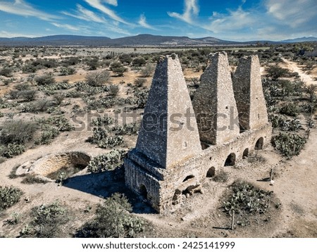 Drone capture of the enduring colonial mining ovens in Mineral de Pozos, Guanajuato, set against the backdrop of the arid Mexican landscape.