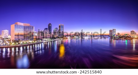 Jacksonville, Florida, USA city skyline panorama on St. Johns River at dawn.