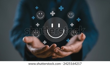 Hands holding happy smile face. mental health positive thinking and growth mindset, mental health care recovery to happiness emotion. Royalty-Free Stock Photo #2425164217