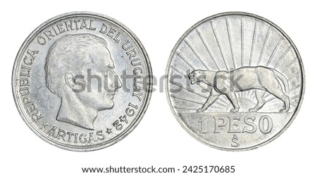 Silver one peso coin from Uruguay featuring puma and "So" mintmark on reverse and profile of Uruguayan founding father José Artigas and 1942 date on obverse--the only date this coin was made.  Royalty-Free Stock Photo #2425170685