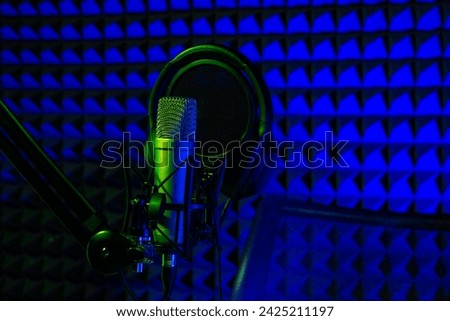 Professional microphone in a recording studio in blue light