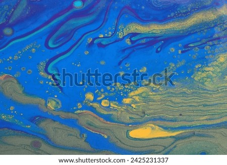 art photography of abstract marbleized effect background with blue and gold creative colors. Beautiful paint.