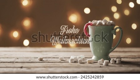 Image of frohe weihnachten text over mug of chocolate with marshmallows and spots of light. Christmas, tradition and celebration concept digitally generated image.