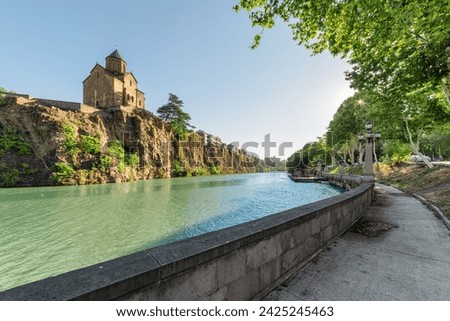 Awesome view of the Virgin Mary Assumption Church of Metekhi on the cliff over the Kura (Mtkvari) River in Tbilisi, Georgia. The Georgian Orthodox Christian church is a popular tourist attraction. Royalty-Free Stock Photo #2425245463