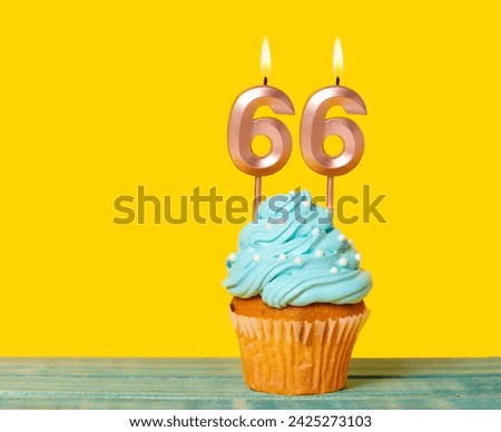 Birthday Cake With Candle Number 66 - On Yellow Background. Royalty-Free Stock Photo #2425273103
