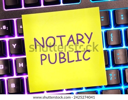 NOTARY PUBLIC is written on a yellow sticker on a bright keyboard background