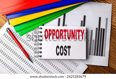 OPPORTUNITY COST text on notebook with pen, folder on a chart background Royalty-Free Stock Photo #2425283679