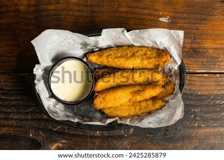 Deep fried pickle spears in a basket Royalty-Free Stock Photo #2425285879