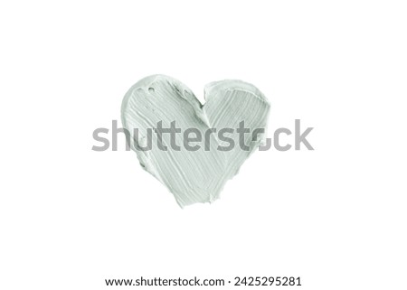 Green clay mask or correcting concealer smear smudge in the shape of a heart isolated on white background. Cream texture. Facial mask, skincare beauty product swatch closeup. SPA background Royalty-Free Stock Photo #2425295281