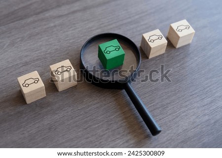 Wooden blocks with car icon and magnifying glass. Choose and buying a right car concept.