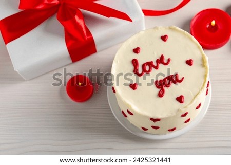 Bento cake with text Love You, candles, gift box and space for text on white wooden table, above view. St. Valentine's day surprise