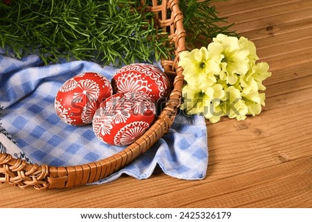 Easter,  spring holiday - beautiful colorful Easter eggs - Czech home tradition of decorating with wax,
classic still life with spring flowers,
