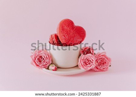 Pink heart shaped french macarons with rose flowers on a pink pastel background. Concept for Valentine's day. Place for text. Royalty-Free Stock Photo #2425331887