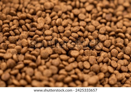 Food for animals background. Dry cat and dog food texture, pattern. Pet meal background close up. Dry food for pet dogs and cats. Dried pet food top view. Granules of good nutrition for dogs and cats. Royalty-Free Stock Photo #2425333657