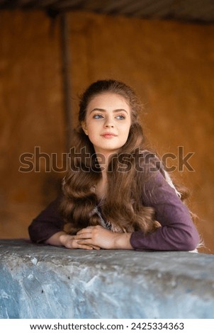 Portrait of beautiful blonde curl girl in medieval dress and fur vest on  nature. Young worker in rural scene.Warm colorful art work.