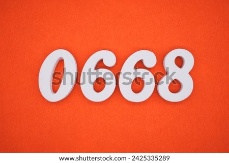 Orange felt is the background. The numbers 0668 are made from white painted wood.