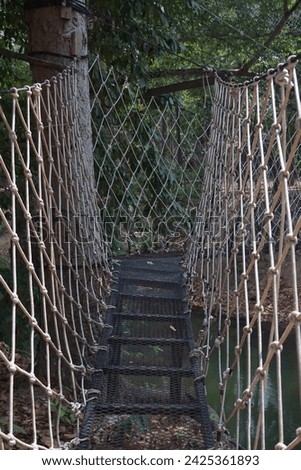 An old wire bridge made of large ropes.