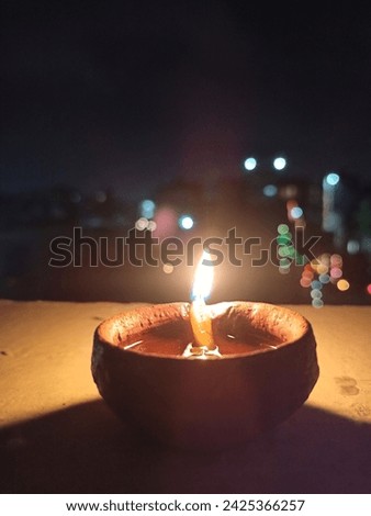 a beautiful pic of a diya (oil lamp made of clay.) on deepavali an Indian festival.