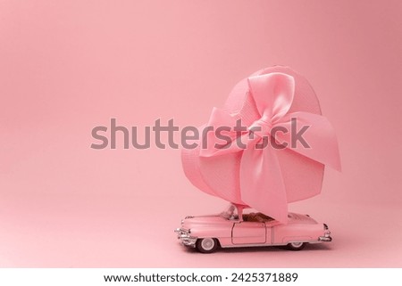 Great present for a lady on 8th march concept. Photo trendy car driving from open unpacked unwrapped present box isolated light color backdrop