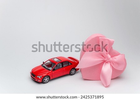 Great present for a lady on 8th march concept. Photo trendy car driving from open unpacked unwrapped present box isolated light color backdrop