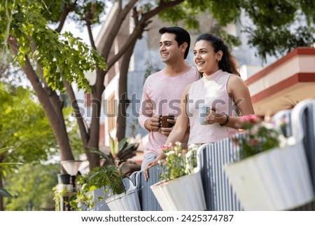 Couple spending leisure time together while drinking coffee outdoors