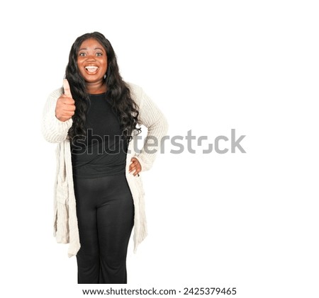 Excited young african woman smiling while doing a thumb up gesture with her hand and wearing a grey jumper against a white background