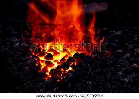 Embers and Flames of a smith's forge Royalty-Free Stock Photo #2425385911