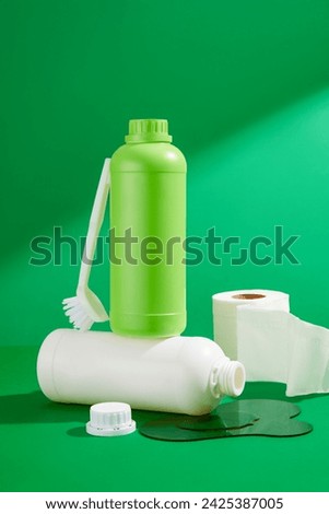 A set of different detergents bottles, brush and paper roll decorated on a green background. Front view, mockup for design packaging. The concept of cleaning service