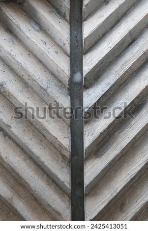 grey cement wall V-shaped triangular pattern 