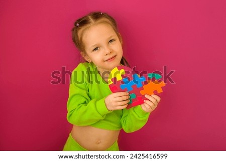 A sweet kind child with a heart-postcard decorated with multicolored puzzles for autism Day