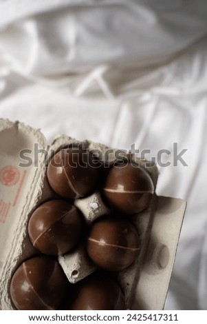 Chocolate eggs on white linen, Easter aesthetically pleasing picture, six chocolate eggs, Easter picture, present 